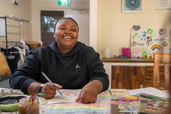 person smiling doing art