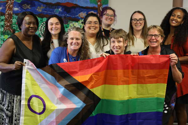 group of people holding an intersex inclusive progress pride flag