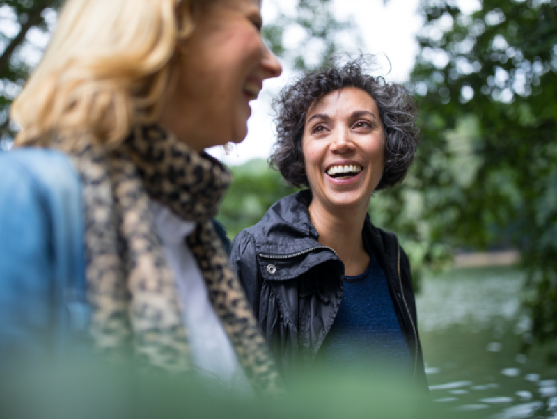 two women outside walking together