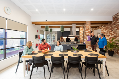 Group of people around a kitchen
