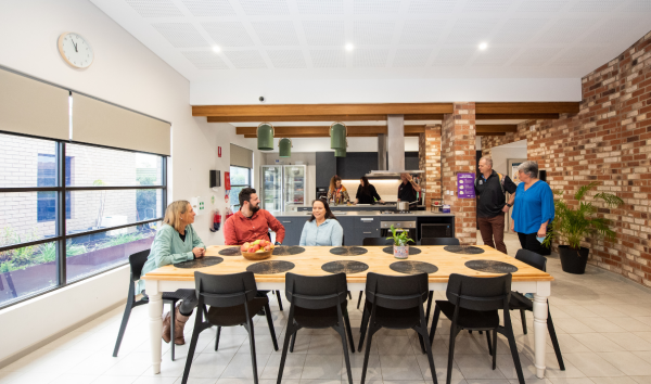Group of people around a kitchen